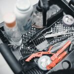 Close-up of hairdressing tools in a salon setting, featuring scissors, combs, and styling products.